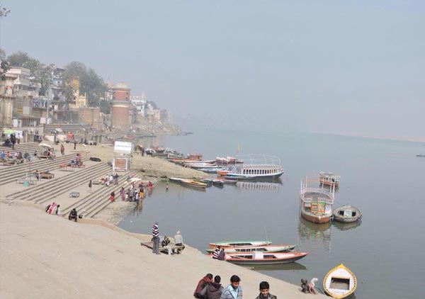 Assi Ghat with boats moored along the steps.