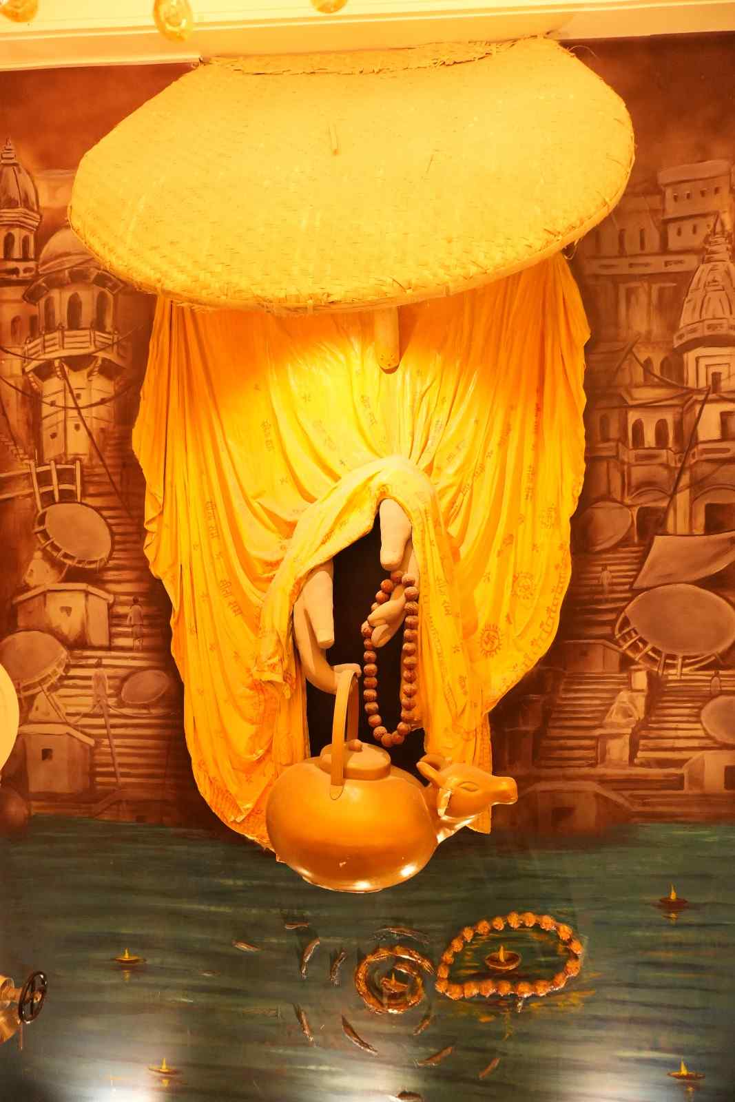 A large illuminated sculpted wall feature lit in warm gold.