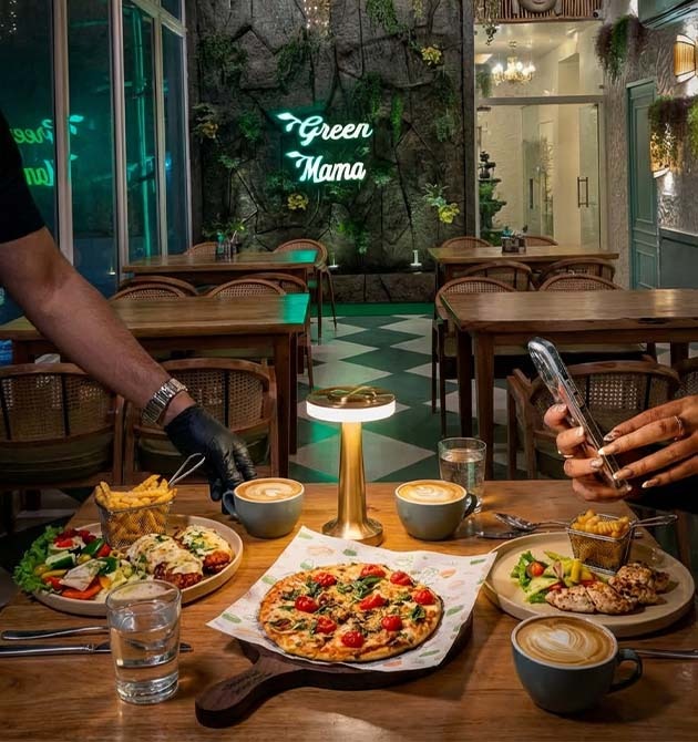 A spread of dishes being served on a table at Green Mama.