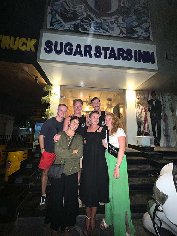 A group of guests photographed at night outside the hotel.