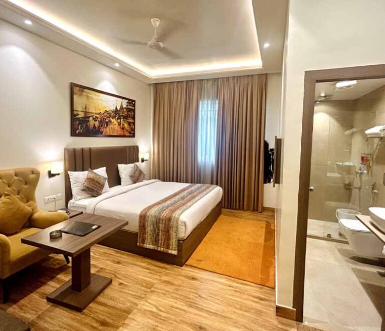 A second view of a guest room showing the desk and television.
